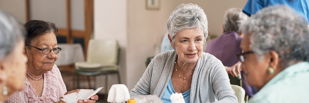 Shot of a group of senior women playing cards together at a retirement home