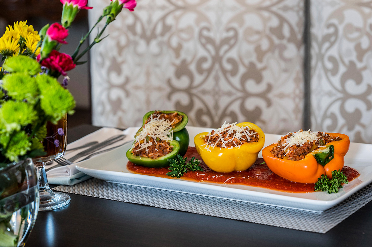 three stuffed peppers on a platter